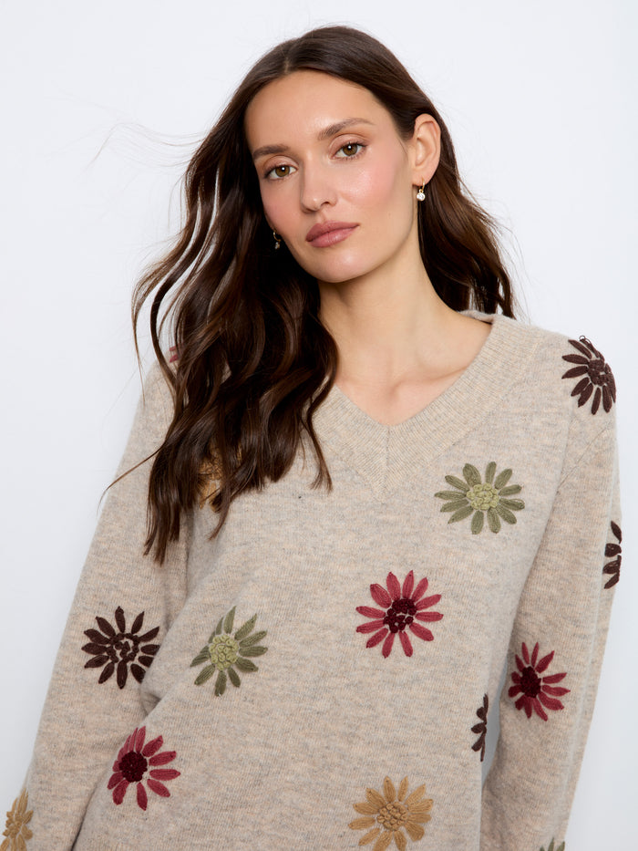 Adorned with ribbed cuffs and hem, this sweater provides both style and comfort. Embroidered by Charlie B.