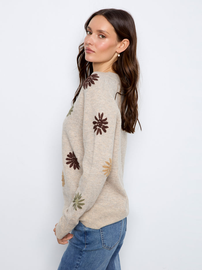 Featuring exquisite floral embroidery, this sweater offers a chic look ideal for any occasion. Designed by Charlie B.