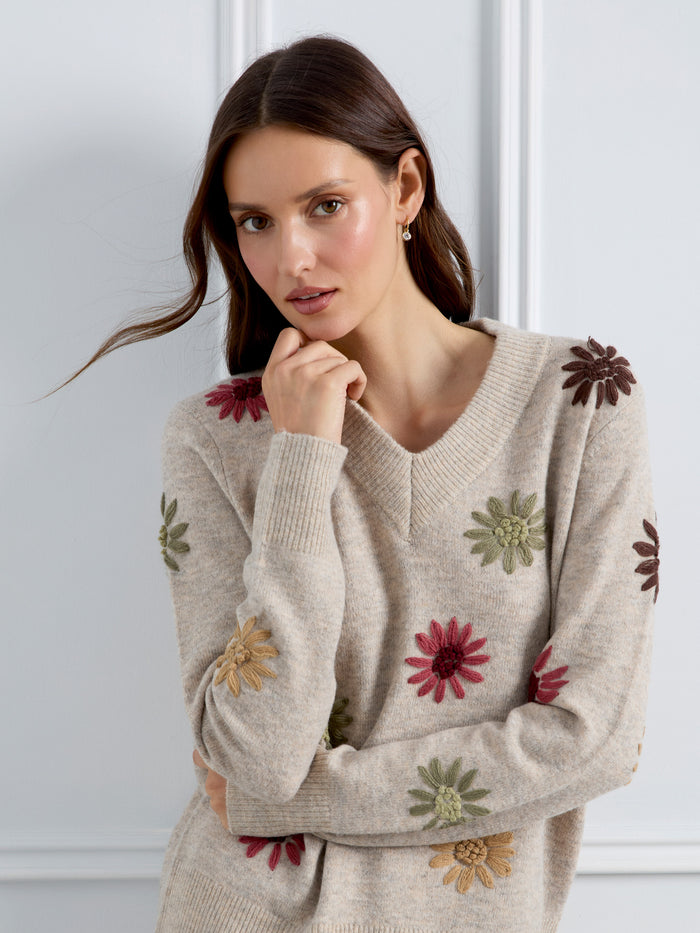 The ribbed hem adds texture to the stylish embroidered sweater, creating an effortlessly elegant outfit. By Charlie B.