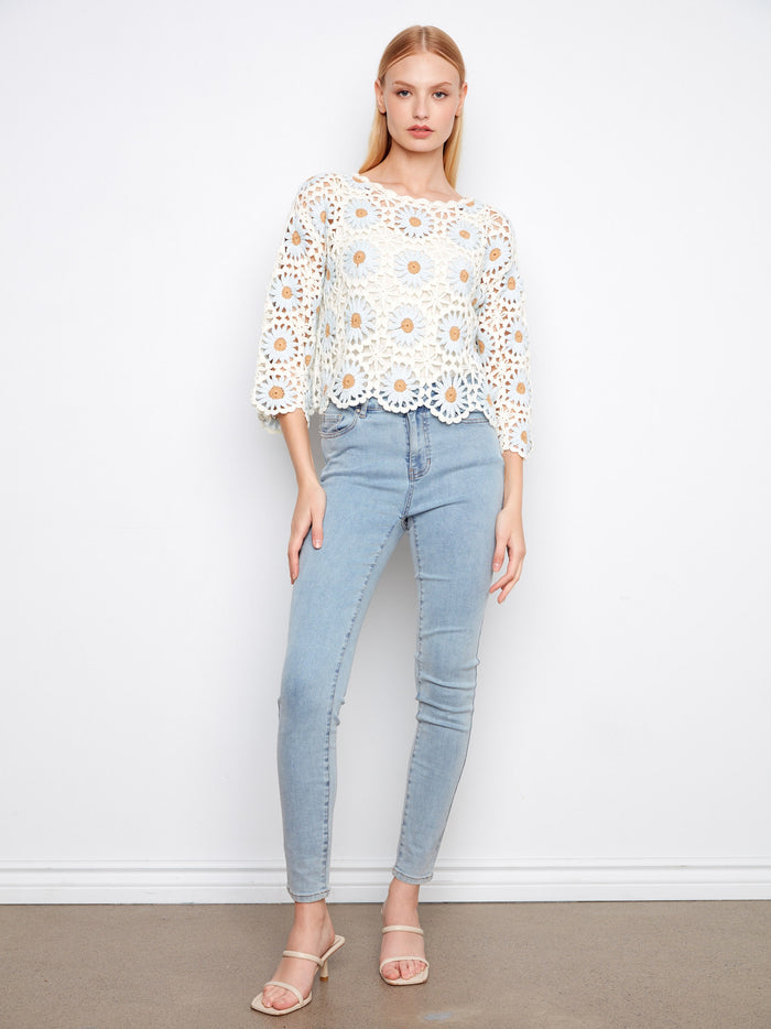 Charming handcrafted crochet sweater featuring a stylish boat neckline and exquisite floral patterns by Charlie B.