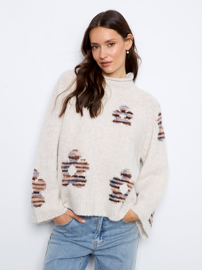 Crafted with intricate patterns, this mock neck sweater brings a touch of elegance to your wardrobe by Charlie B.