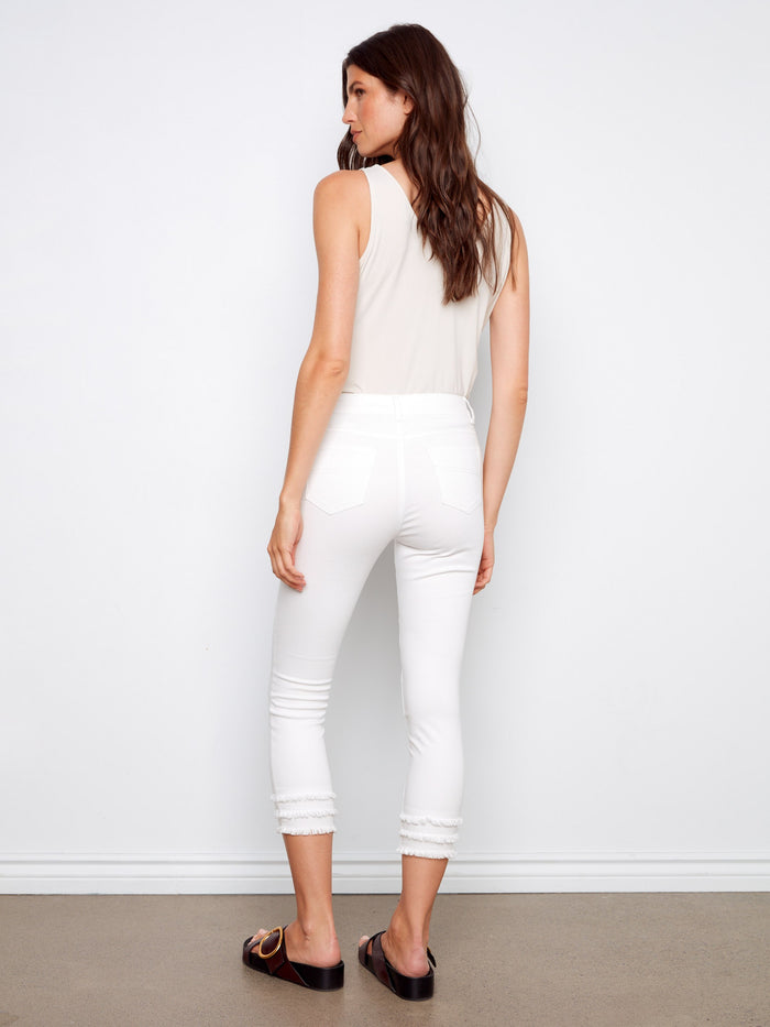 These white cropped pants boast five pockets and a stylish skinny fit, complete with frayed hem details by Charlie B.