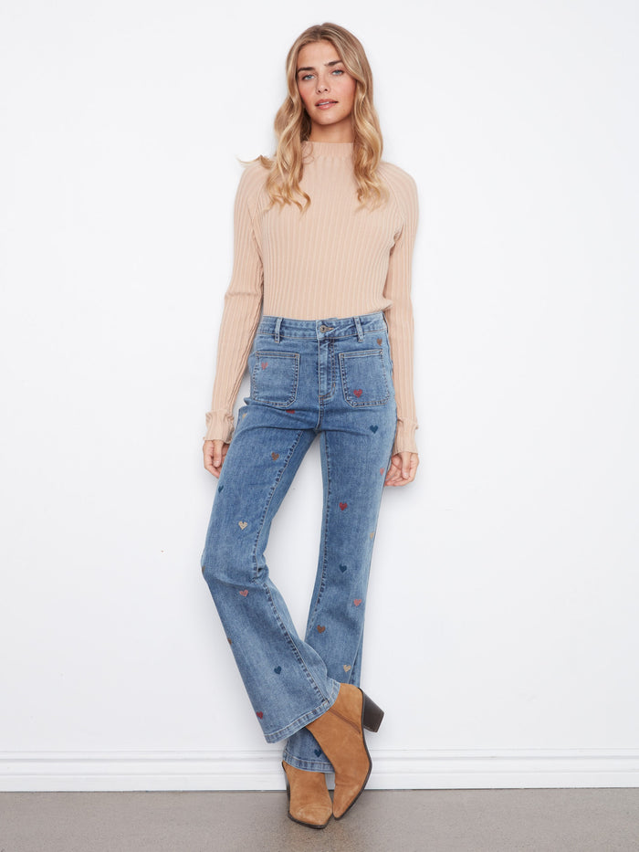 Denim jeans featuring a flare leg design, perfect for adding a touch of style to any outfit. Crafted with care by Charlie B.