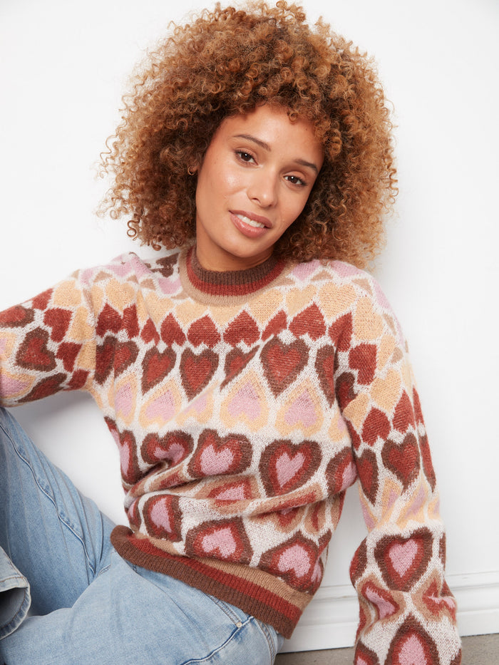 Fashionable mock neck sweater showcasing intricate jacquard hearts for a trendy touch by Charlie B.