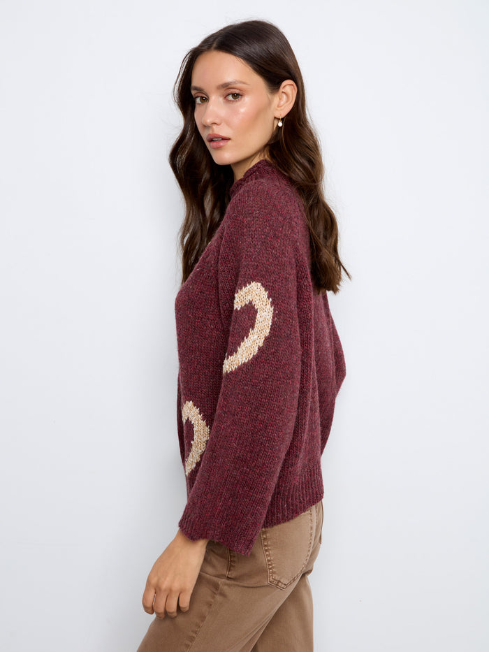 Unique design with 3/4 bell sleeves adds flair to this heart-patterned sweater, making it versatile for any occasion. By Charlie B.