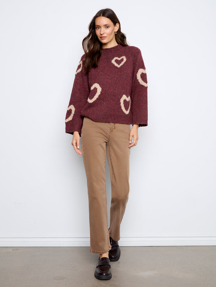 A chic addition to your wardrobe, this mock neck sweater offers comfort in its relaxed fit while displaying lovely hearts. By Charlie B.