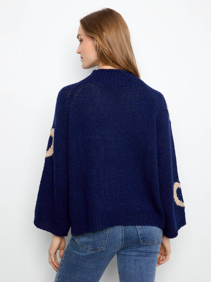 Chic navy sweater adorned with heart motifs, boasting 3/4 bell sleeves for added flair by Charlie B.
