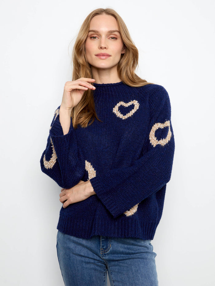 Fashionable relaxed fit sweater in navy, highlighted by a mock neck and lovely heart patterns by Charlie B.