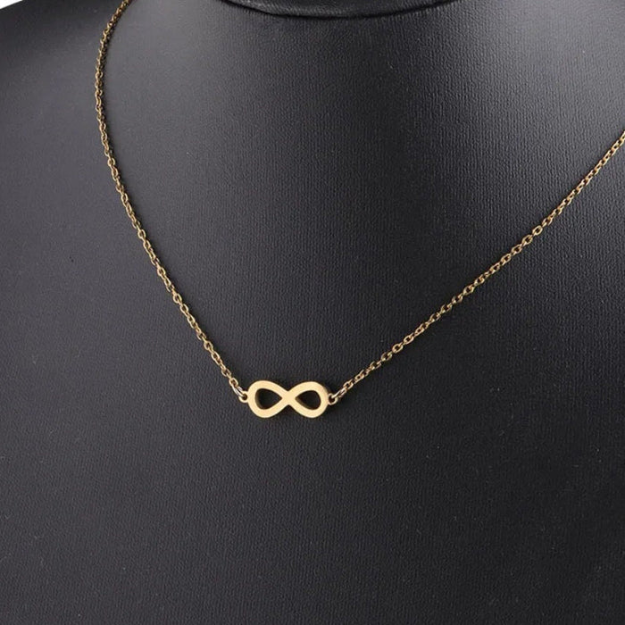 infinity necklace in gold and silver on a display mannequin, symbolizing eternity and love.