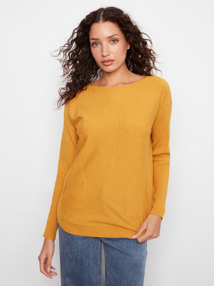 Sweater featuring a chic boat neck neckline, perfect for any casual outing. Crafted in a warm hue, this piece is by Charlie B.