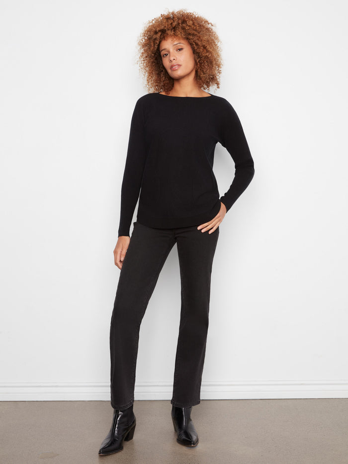 Chic black knit sweater with a rounded hem and boat neck, perfect for versatile styling options by Charlie B.