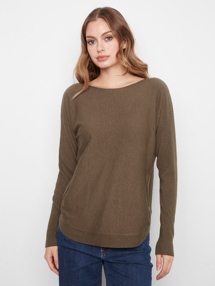 Olive sweater featuring a boat neck design, perfect for casual outings. The ribbed sleeves add a touch of elegance. By Charlie B.