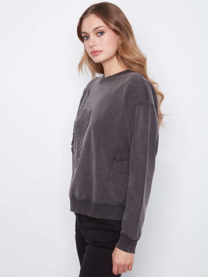 Chic charcoal top showcasing floral appliqué detail for added elegance by Charlie B.
