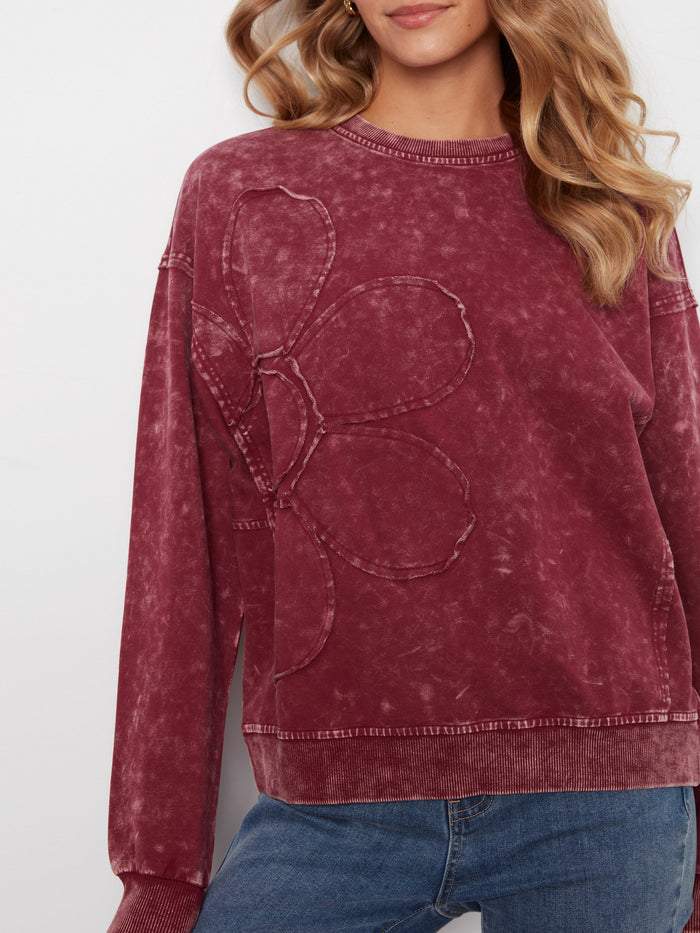 Showcasing a floral appliqué detail, this sweater adds a unique and artistic flair to your wardrobe. Crafted with care by Charlie B.