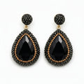 Mila black stone pendant earrings featuring large black crystals and rhinestones in a luxurious design.
