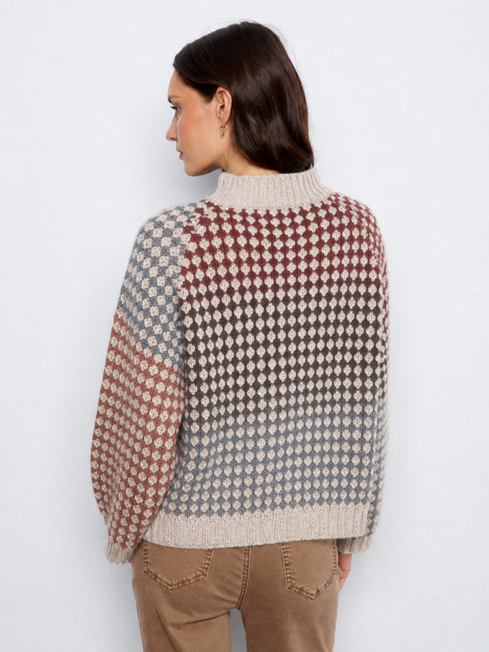 Beautifully crafted with attention to detail, this sweater combines style and comfort effortlessly. By Charlie B.