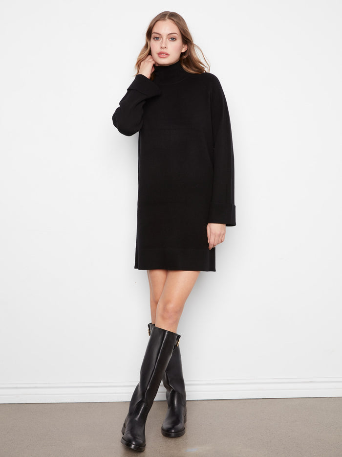 Black sweater dress designed with long raglan sleeves, combining style and warmth effortlessly by Charlie B.