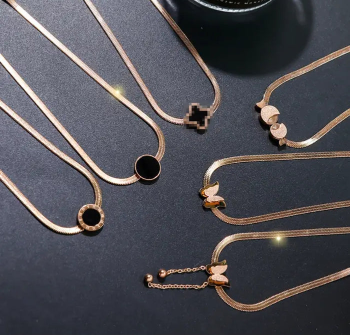 NIDA charm necklace showcasing intricate pendant designs in elegant gold tones, ideal for layering or wearing alone.