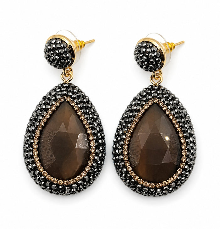 Nisa stone pendant earrings in bronze with rhinestone embellishments, featuring teardrop stone design.