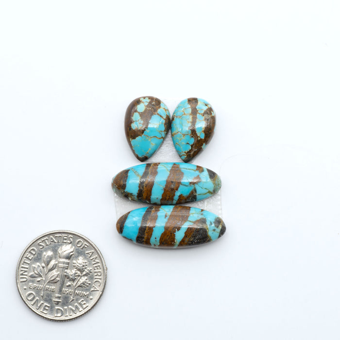 Number 8 Turquoise cabochons, blue and green color with brown matrix, polished stones on a white background, with a US dime for scale