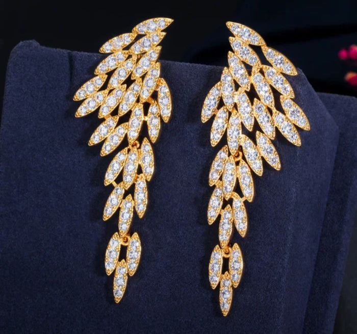 Nysa feather earrings featuring cascading angel wing drops adorned with marquise-cut cubic zirconia crystals.