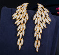 Nysa feather earrings featuring cascading angel wing drops adorned with marquise-cut cubic zirconia crystals.