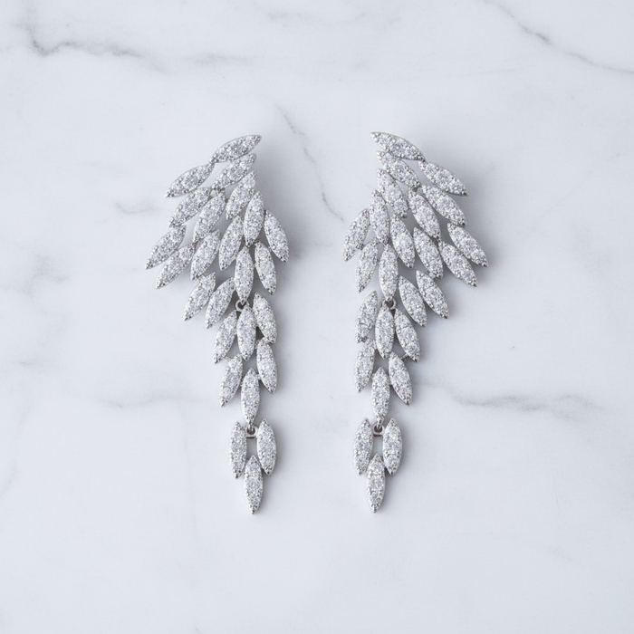 Nysa feather earrings featuring cascading angel wing drops with marquise-cut cubic zirconia crystal leaf petals.