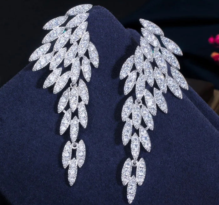 Nysa feather earrings with cascading angel wing drops featuring marquise-cut cubic zirconia leaf petals.