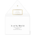 Gold decorative box holding the return address on the back of the envelope flap. Small circle logo on the tip of the flap. Black deco and block copy centered on the front of the envelope.