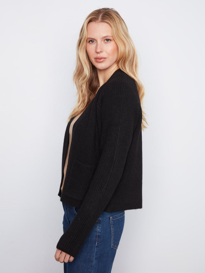 Chic black cardigan with elegant open-front design, highlighted by practical patch pockets at the waist by Charlie B.