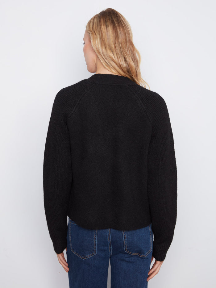 Stylish black cardigan featuring classic raglan sleeves and functional patch pockets for added flair by Charlie B.