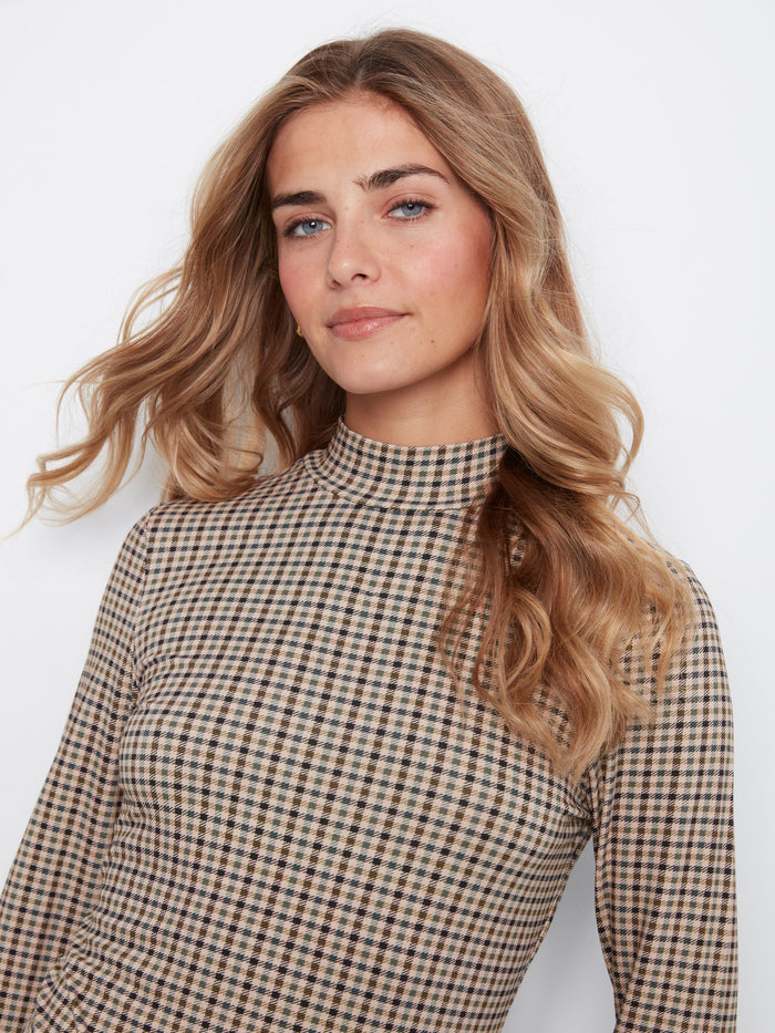 Slim fit design accentuates the plaid mock neck top in coffee by Charlie B.