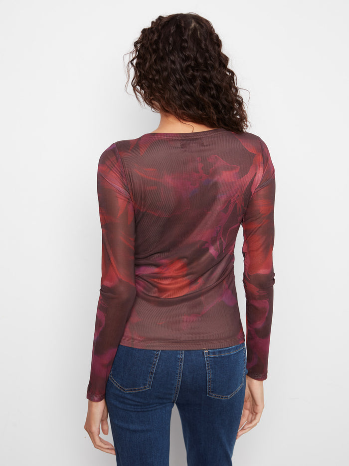 Adorned with a vibrant floral pattern, this top adds a touch of nature-inspired beauty by Charlie B.