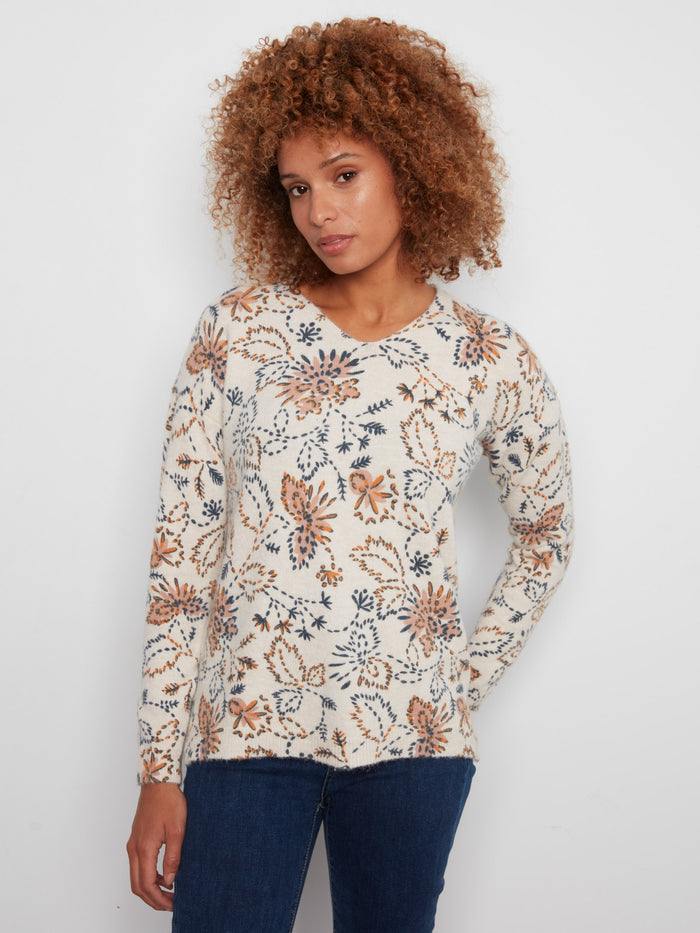 Floral print sweater with a V-neck and side slits, offering a stylish and comfortable look by Charlie B.