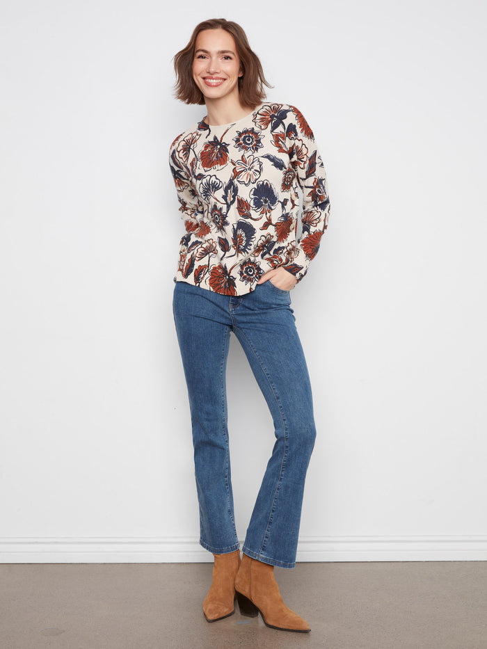 The crew neck of this floral sweater ensures comfort while maintaining an elegant appearance for versatile wear. By Charlie B.