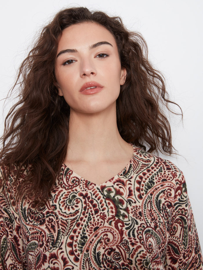 The side slits at the cuffs and hem offer a modern twist to this classic patterned top, enhancing its overall appeal. By Charlie B.