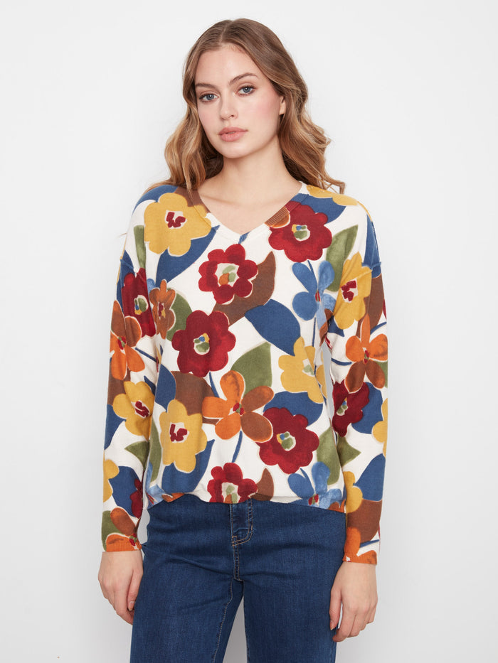 This reversible print sweater showcases vibrant florals, offering two looks in one. A must-have versatile piece by Charlie B.