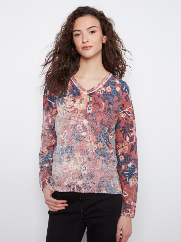 Elegant floral top with drop shoulders, offering a relaxed fit. Made from a cozy cotton blend for ultimate comfort by Charlie B.
