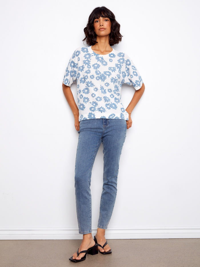 Featuring short sleeves and a charming floral pattern, this top is both stylish and comfortable for everyday wear. By Charlie B.
