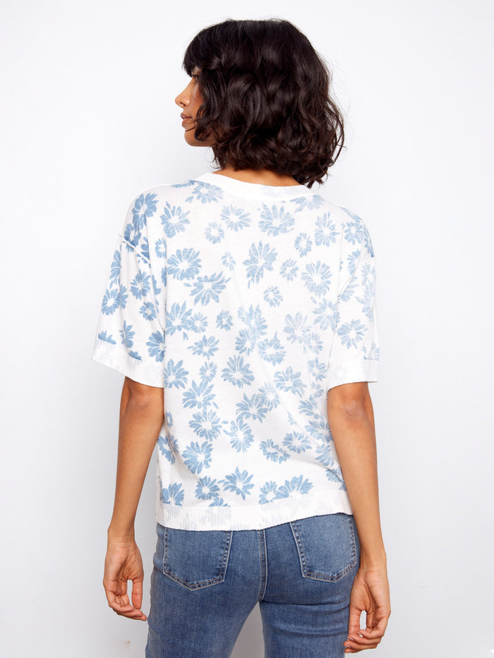 A versatile addition to your closet with its classic crew neckline and elegant floral motif—ideal for any occasion. By Charlie B.