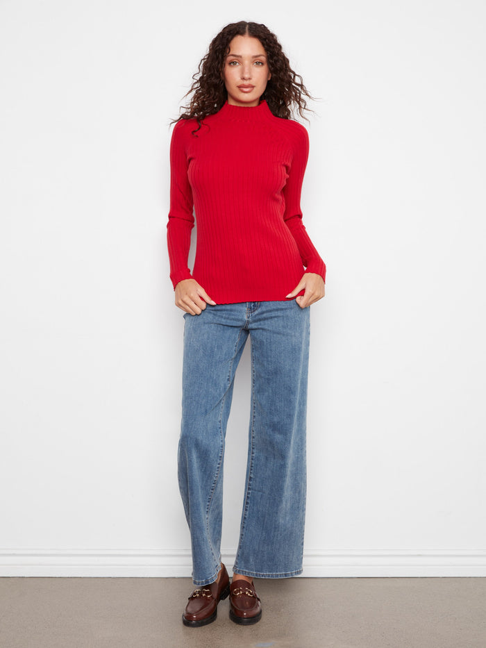 The ribbed texture of this stunning red sweater provides both warmth and style, perfect for transitioning seasons by Charlie B.
