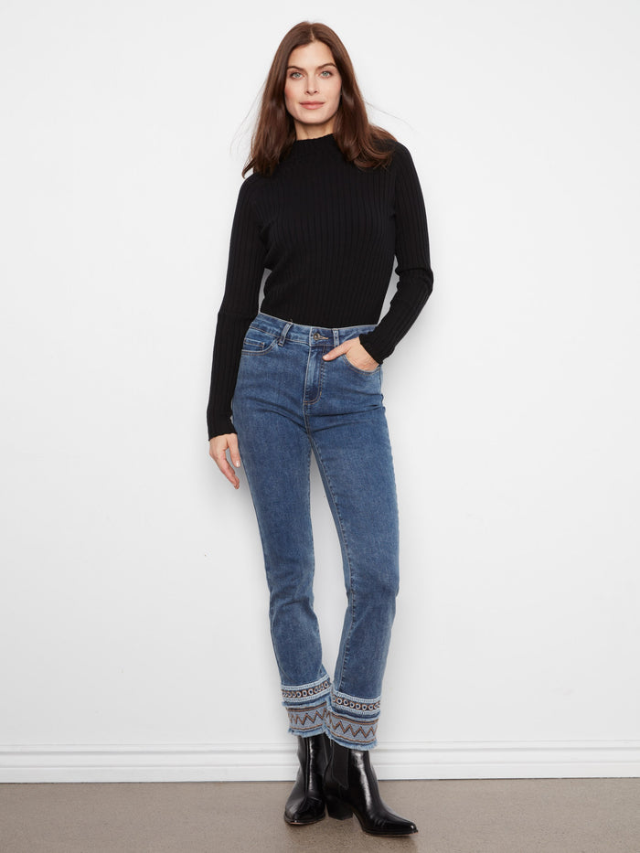 Medium blue jeans featuring a slim fit and intricate embroidered hem, crafted from stretch denim by Charlie B.