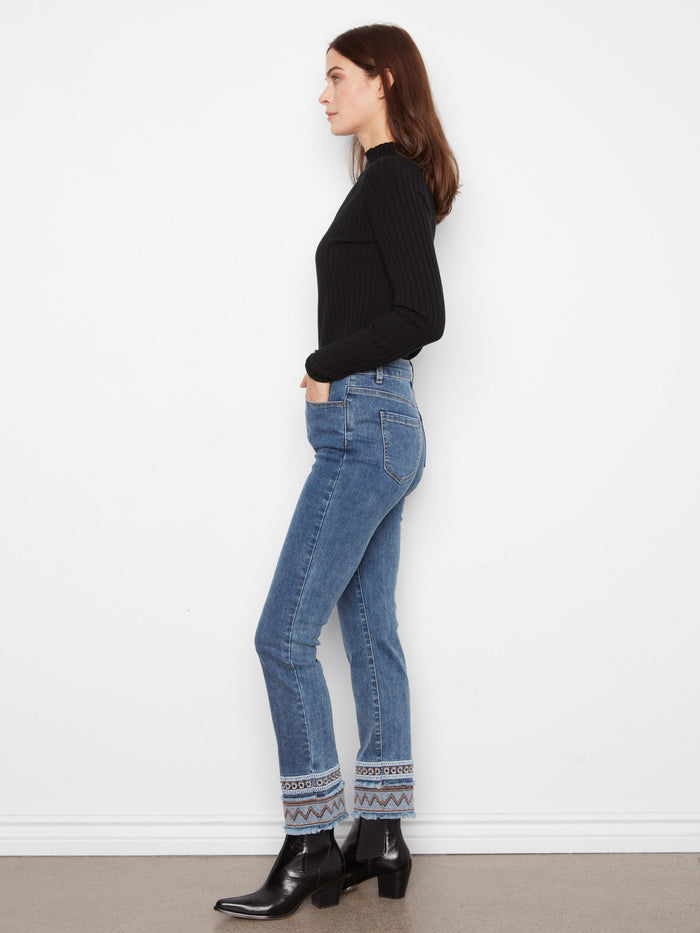 These medium blue jeans boast ankle-length style with a unique embroidered hem accent by Charlie B.