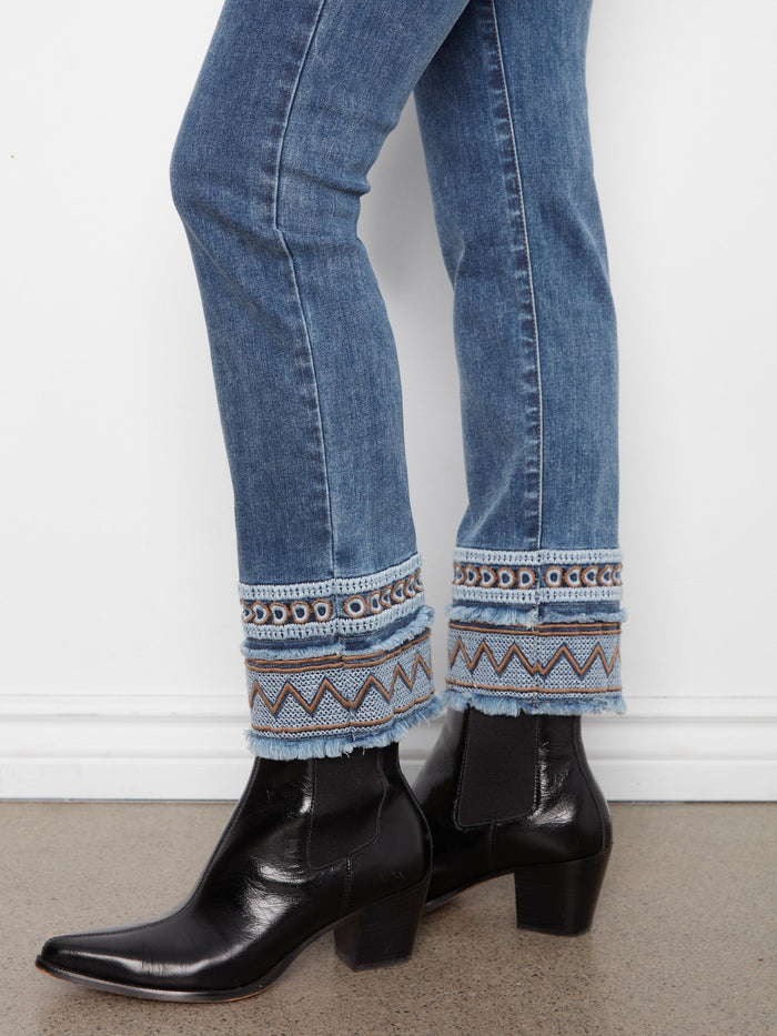 Medium blue jeans designed with stretch denim for comfort, complete with an elegant button closure by Charlie B.