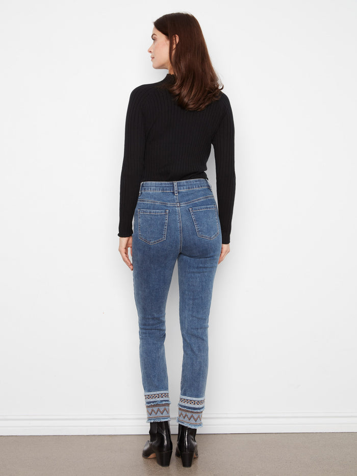 Fashion-forward medium blue jeans showcasing detailed embroidery at the hems, perfect for any occasion by Charlie B.