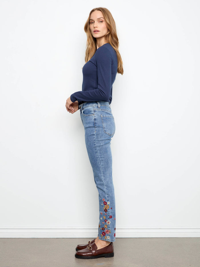 Regular rise jeans in medium blue with exquisite floral embroidery along the hemline by Charlie B.