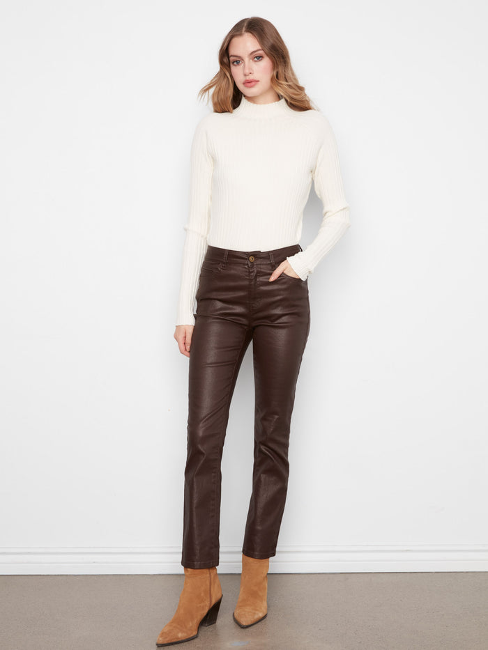 Coffee-colored slim leg pants with ankle length design, styled with a white top and boots by Charlie B.