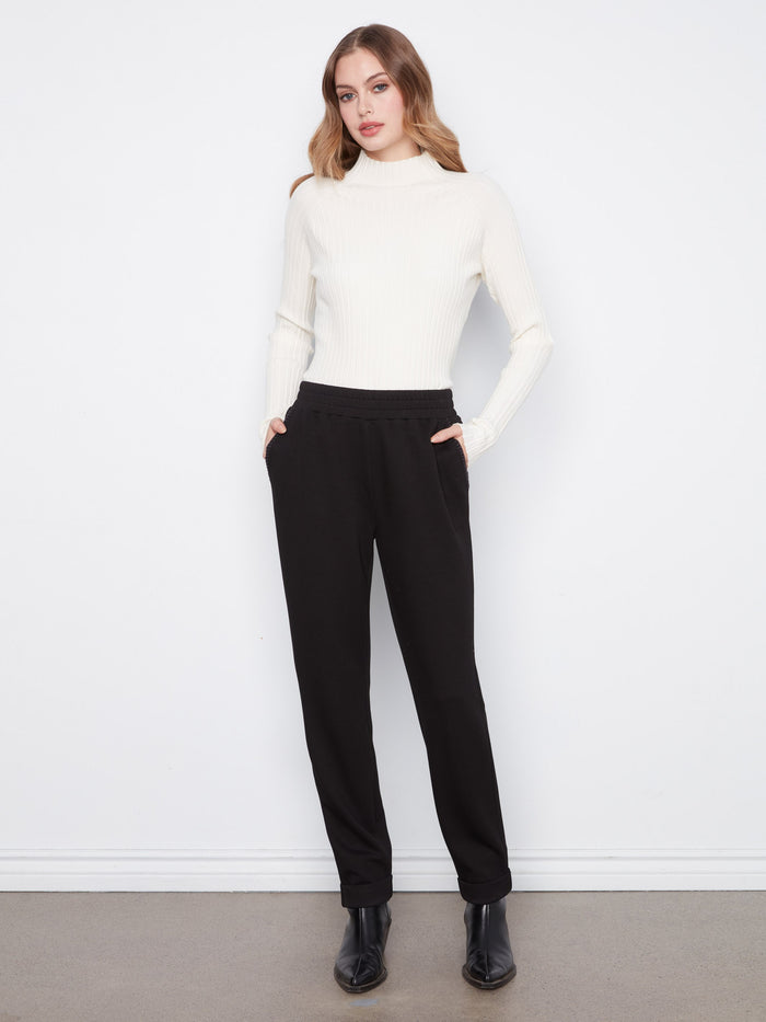 These pants feature a tapered fit, offering a sleek and modern silhouette by Charlie B.