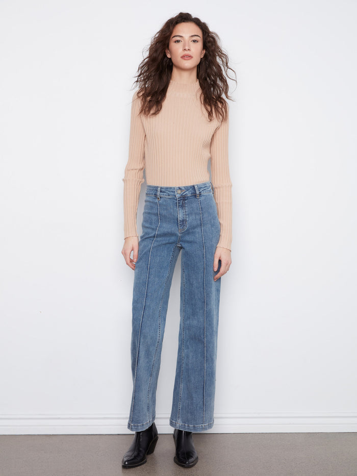 These jeans feature an extra-wide leg design, offering a trendy and comfortable fit by Charlie B.