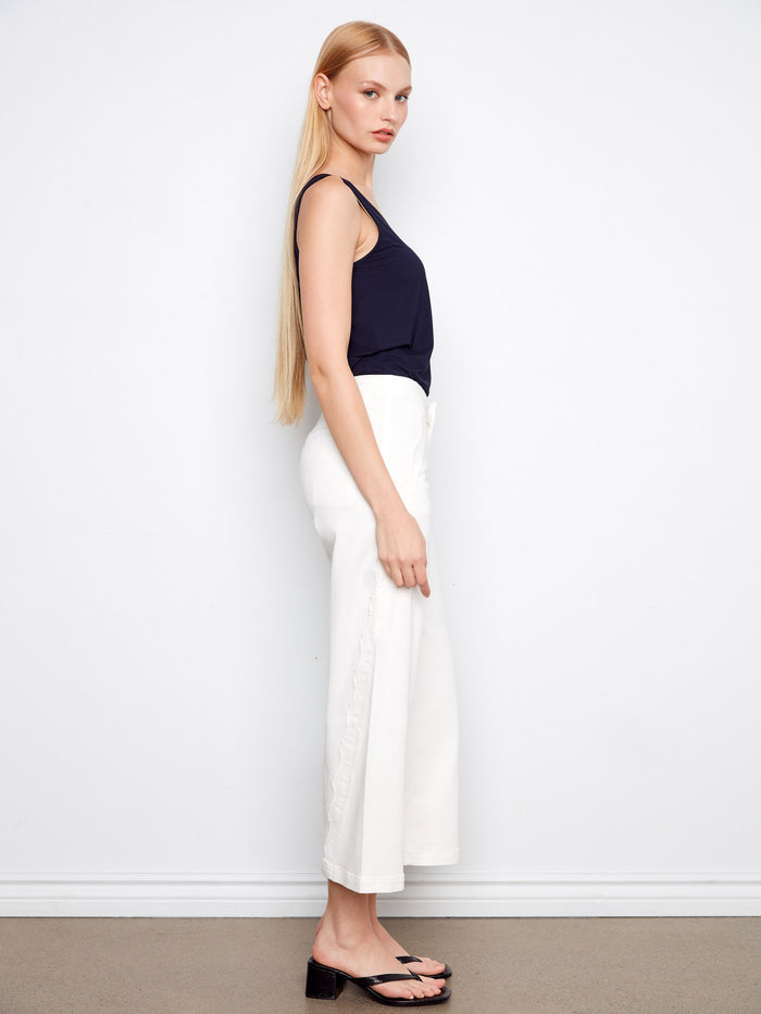 Crafted with scalloped edges, these pants add a touch of elegance to your wardrobe essentials. By Charlie B.
